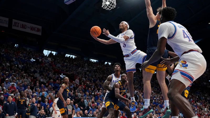 Kansas guard Dajuan Harris Jr. (3) puts up a shot during the first half of an NCAA college...